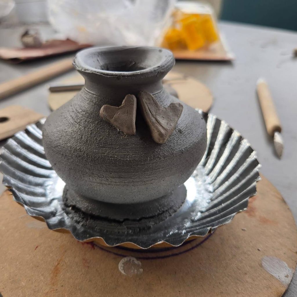 Sculpted clay pot designs with geometric and organic patterns.