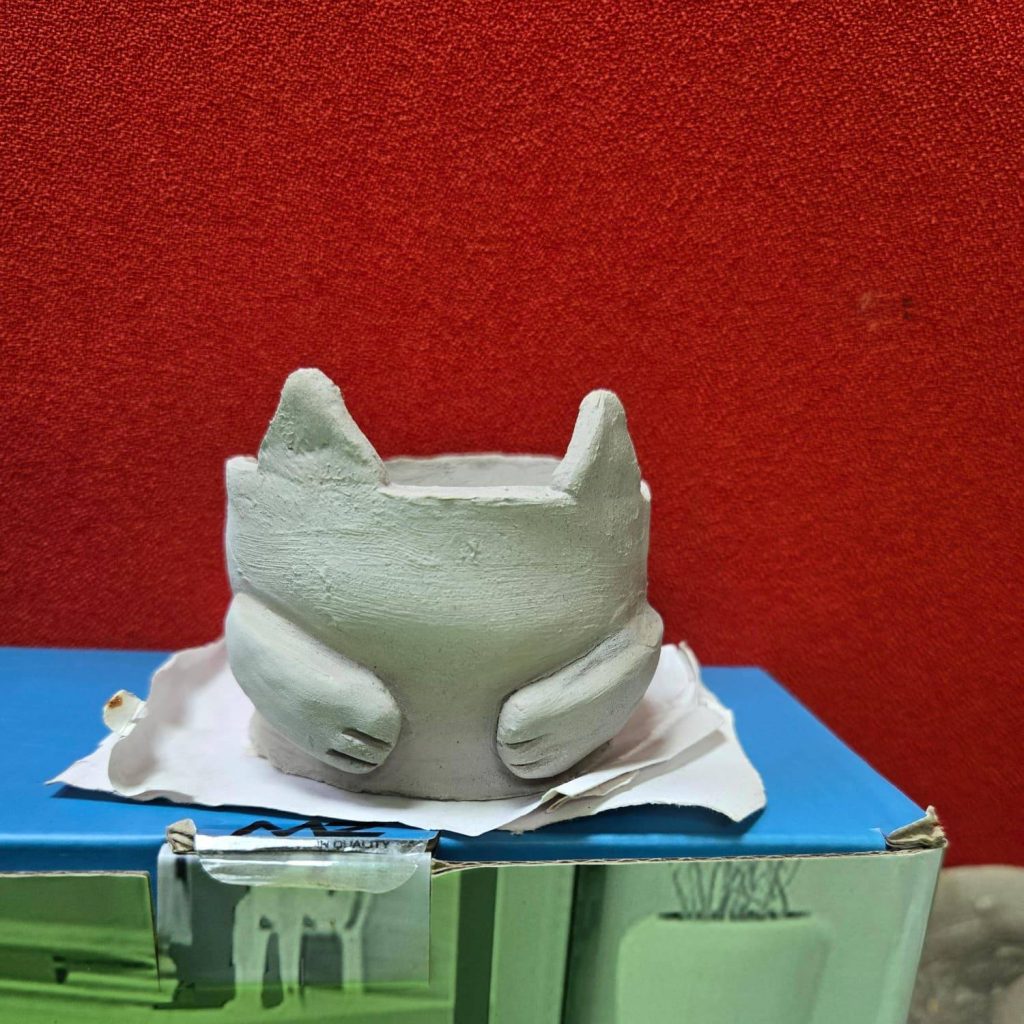 Artisan clay figure sculpture with fine handcrafted details.