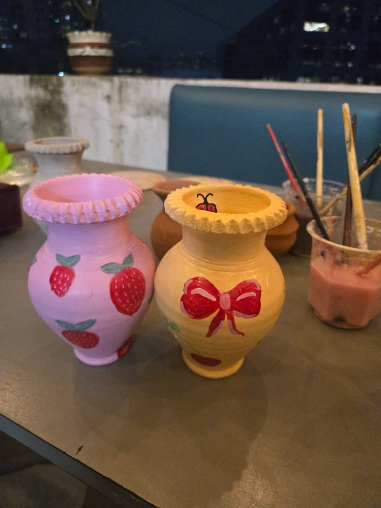 Pottery painting workshop showing paint-your-own ceramic pieces.