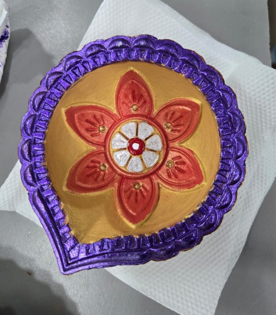 Floral-patterned pottery bowl painted in soft pastel colors.
