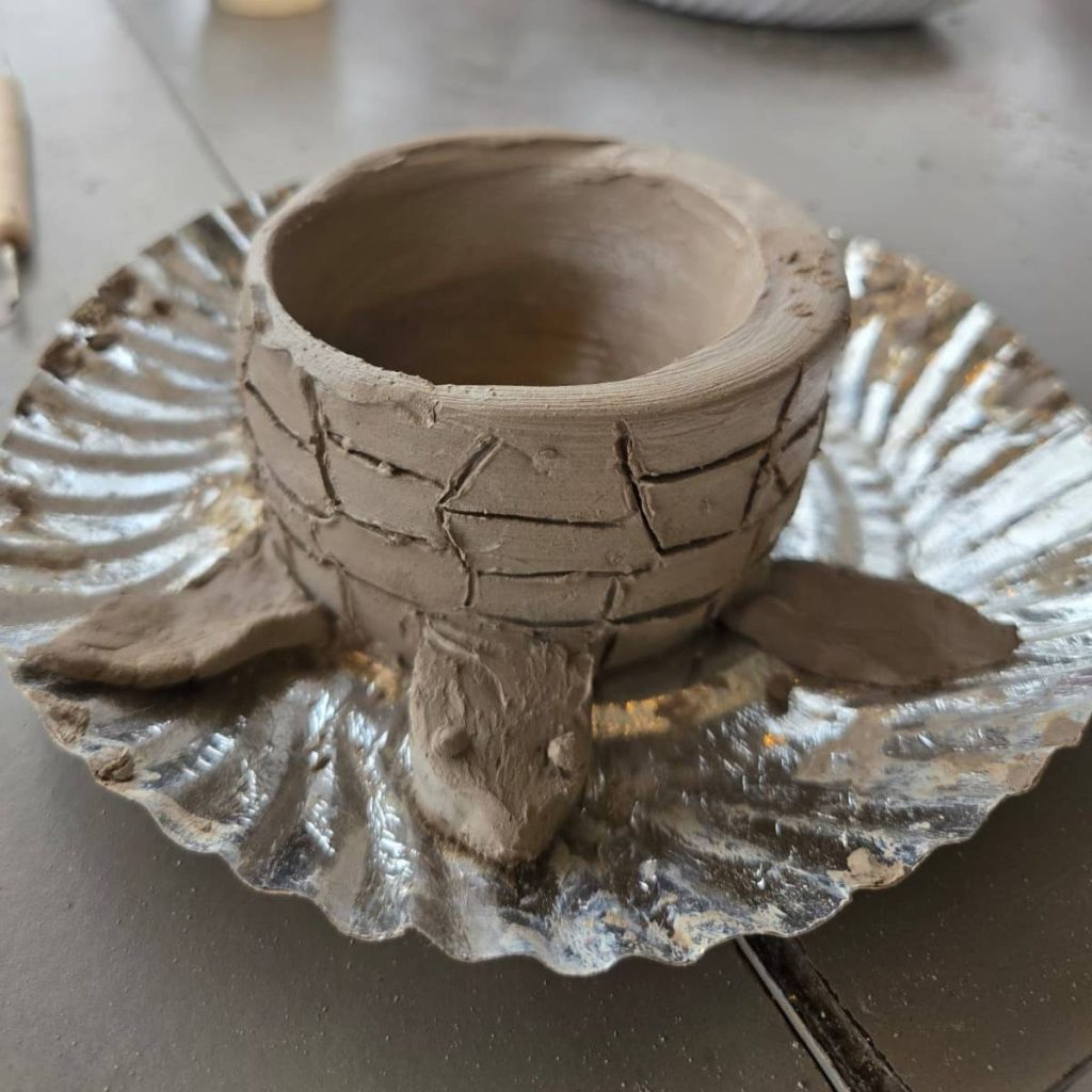 Clay sculpting techniques shown in pottery workshop.