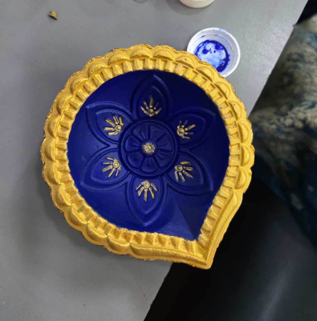 Display shelf in a pottery painting studio with painted ceramics.