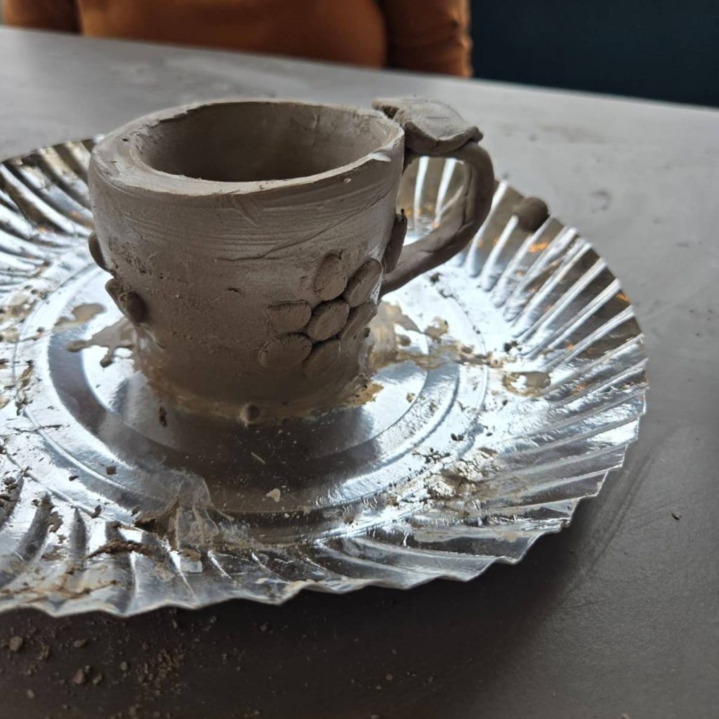 Fine clay art carving details in an artisan pottery piece.